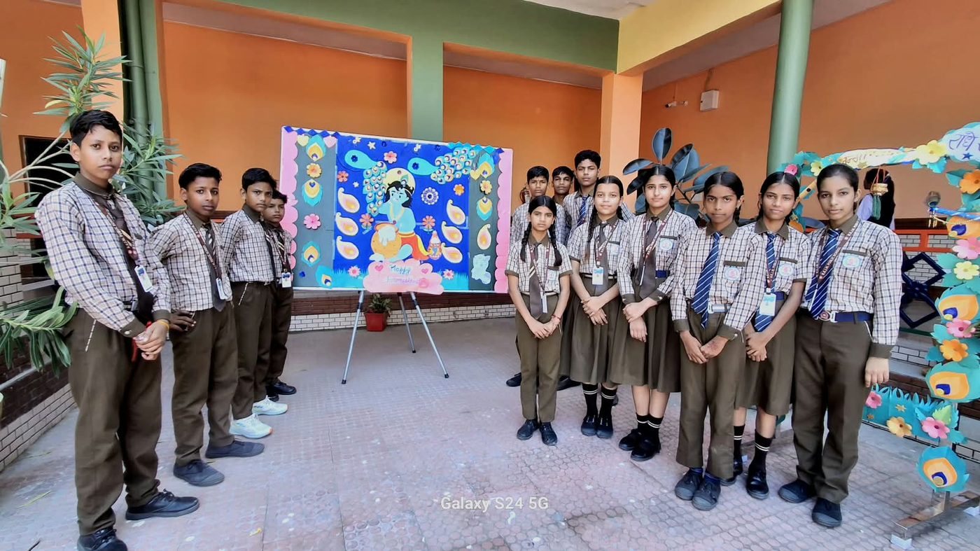 Students beside a Janmashtami art display