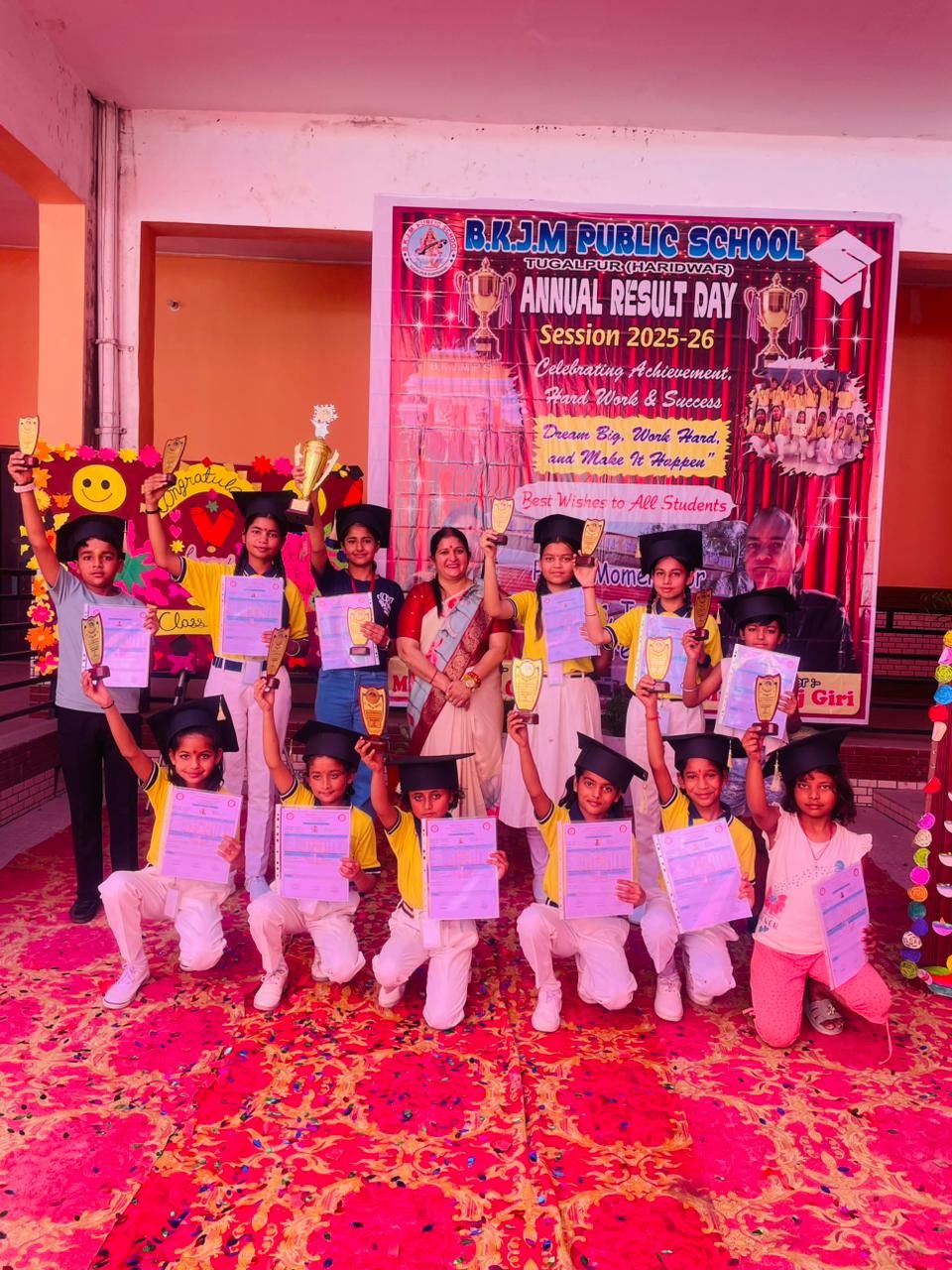 A group of students in graduation caps holding their certificates