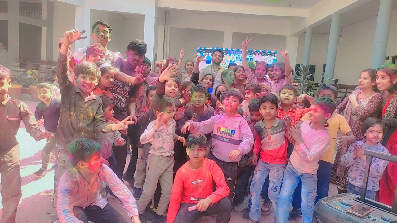 Students celebrating Holi with colours